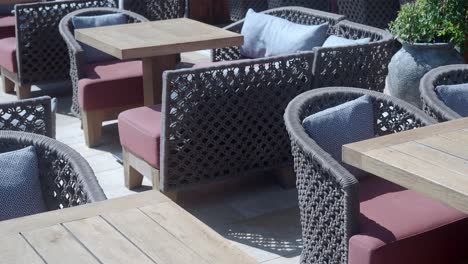 empty outdoor seating area with tables and chairs