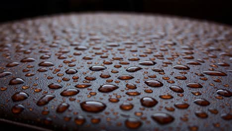 close-up of water droplets on a brown surface, showcasing the intricate patterns and textures created by rainfall accumulating on a smooth material