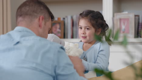 father and daughter playing with teddy bear toys at home little girl having fun enjoying playful game with dad 4k footage