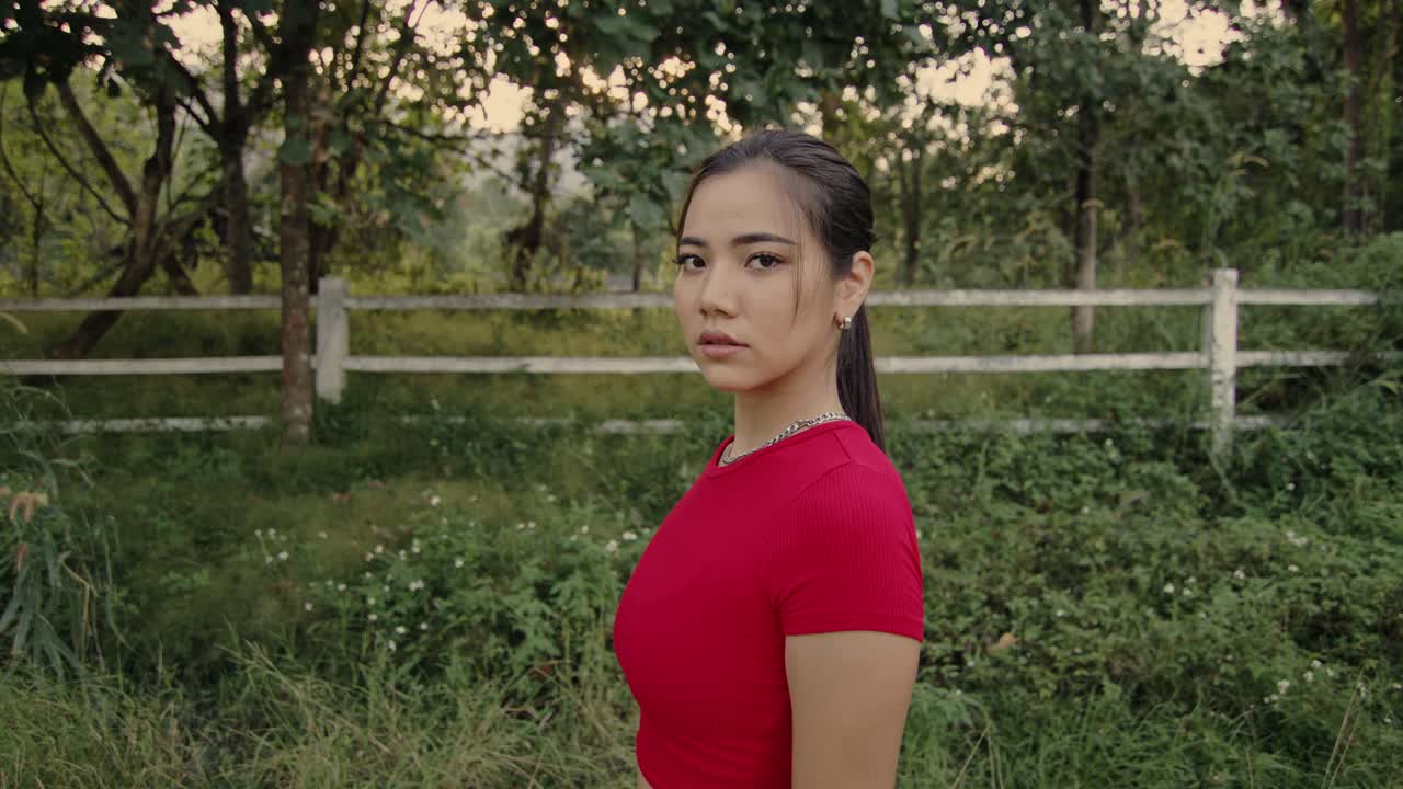 Woman in a Red Shirt in a Field