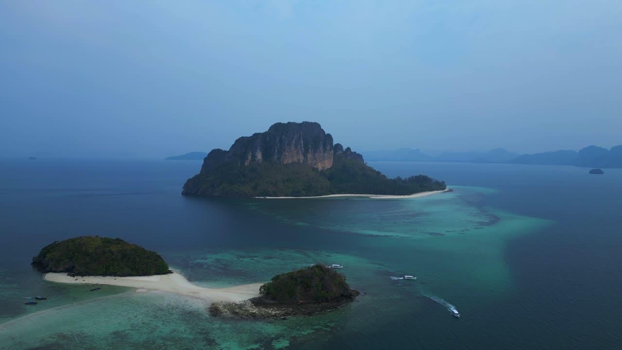 Ko Kai island with turquoise tropical sea and speed boat, Krabi, Thailand. Beautiful aerial view flight panorama orbit drone