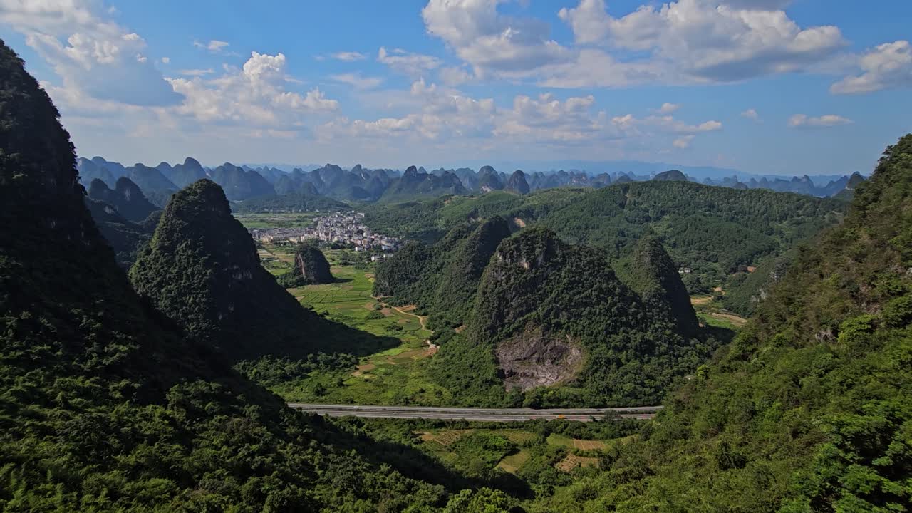 POV shot of a family walking on a glass bridge at Ruyi Peak, in Yangshuo, China