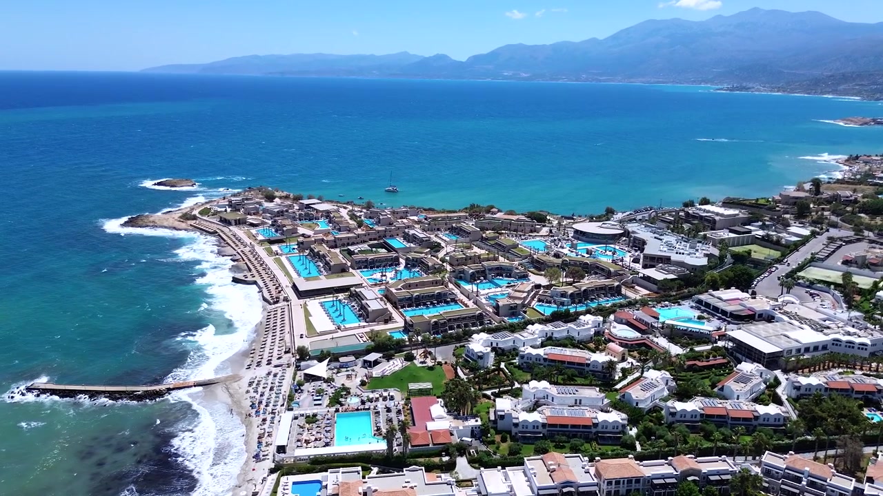 Yunanistan'ın Girit adasında, deniz kenarında lüks daireler ve yüzme havuzları bulunan çarpıcı Nana Royal otel kompleksi, havadan görünüm.
