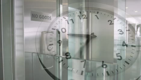 animation of ticking clock against elevator going down at modern office