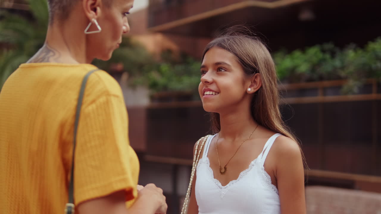 Mother and Daughter Walking in City