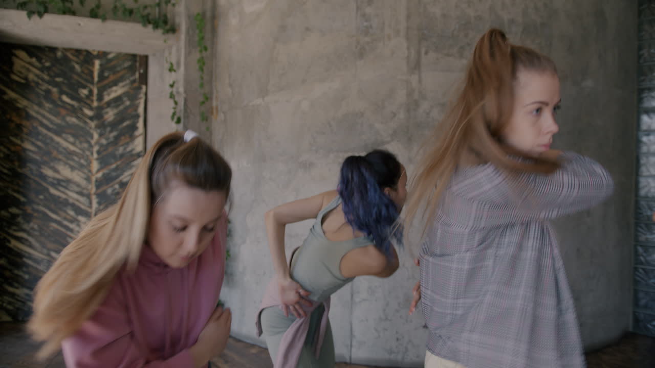 Group of young women practicing dance moves in a dance studio