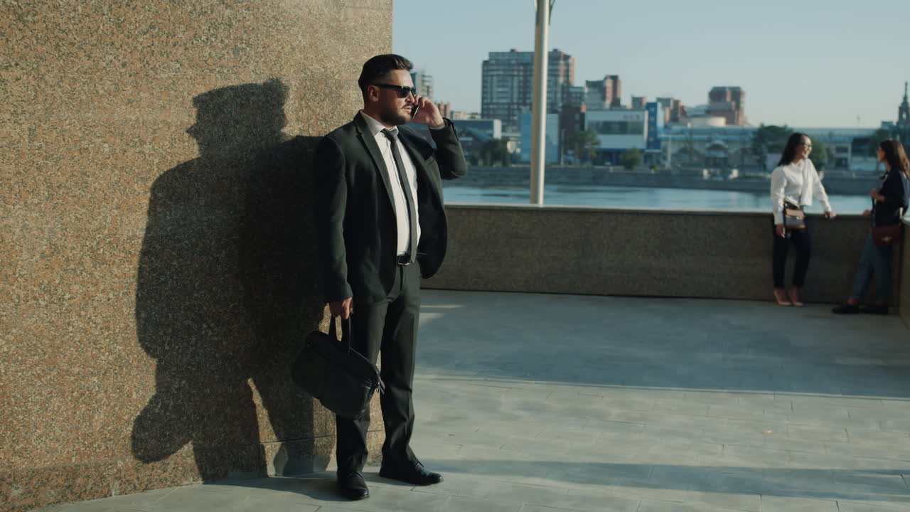 Businessman on a phone call outdoors