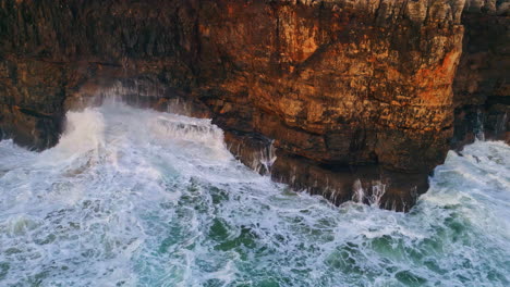 stormy waves splashing crashing high rocks aerial view. dangerous ocean foaming.