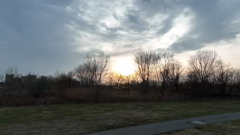 a low angle shot of calvert vaux park in brooklyn, ny during a cloudy sunset