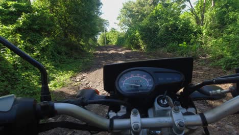 Moto-POV:-Motorcycle-climbs-steep-rutted,-eroded-country-dirt-road