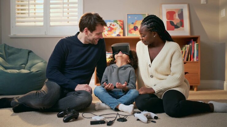 Reacting child wearing gray hoodie tilting up at home, VR headset starting VR demo with controllers