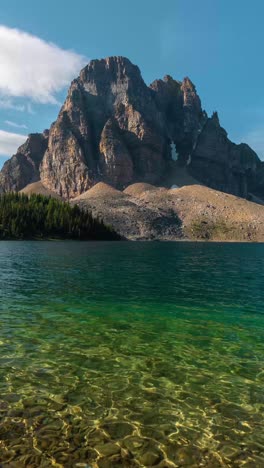 Vertical-4k-Timelapse,-Mountain-Summit-Above-Clear-Alpine-Lake-on-Sunny-Summer-Day