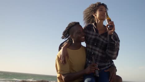 woman sitting on mans lap at beach 4k