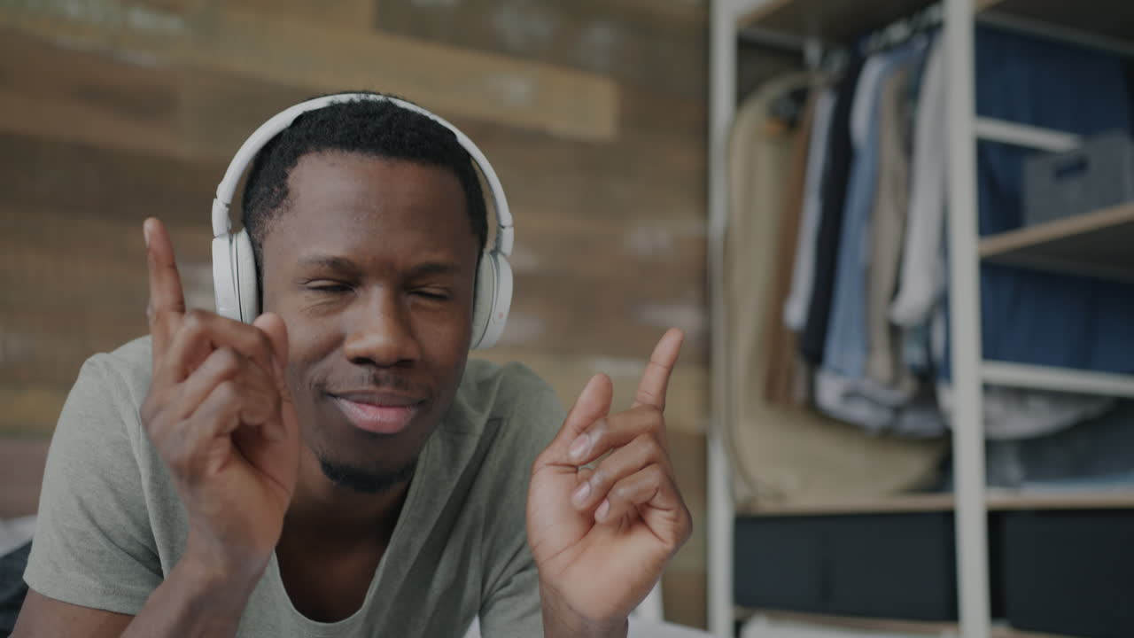 Man Dancing to Music in Bedroom