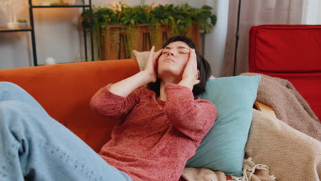 woman rubbing temples to cure headache problem suffering from tension and migraine stress pain