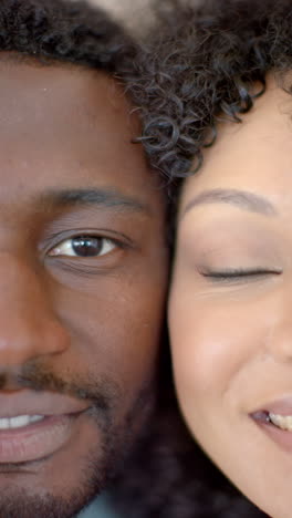 vertical video: smiling couple enjoying intimate moment together at home, close-up shot