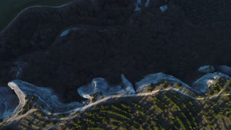 aerial view of a scenic landscape with cliffs and forest