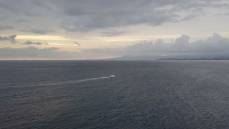 aerial view of white yacht in the middle of a moody overcast ocean