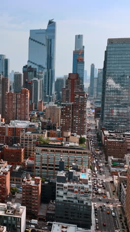usual building contrasting with gorgeous skyscrapers. drone flight above new york on sunny day. vertical video