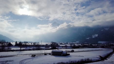 Ein-Auto-Und-Ein-Zug-Fahren-In-Einer-Wunderschönen-Winterlandschaft-In-Der-Schweiz-Nach-Rechts