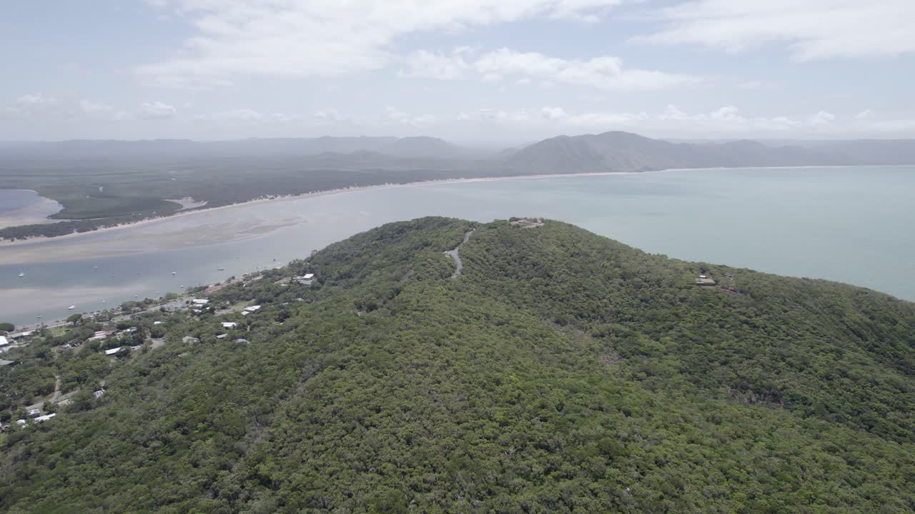 drone volando colina cubierta de hierba hacia el mirador con una vista impresionante del mar de coral y la entrada del río esfuerzo en cooktown, queensland