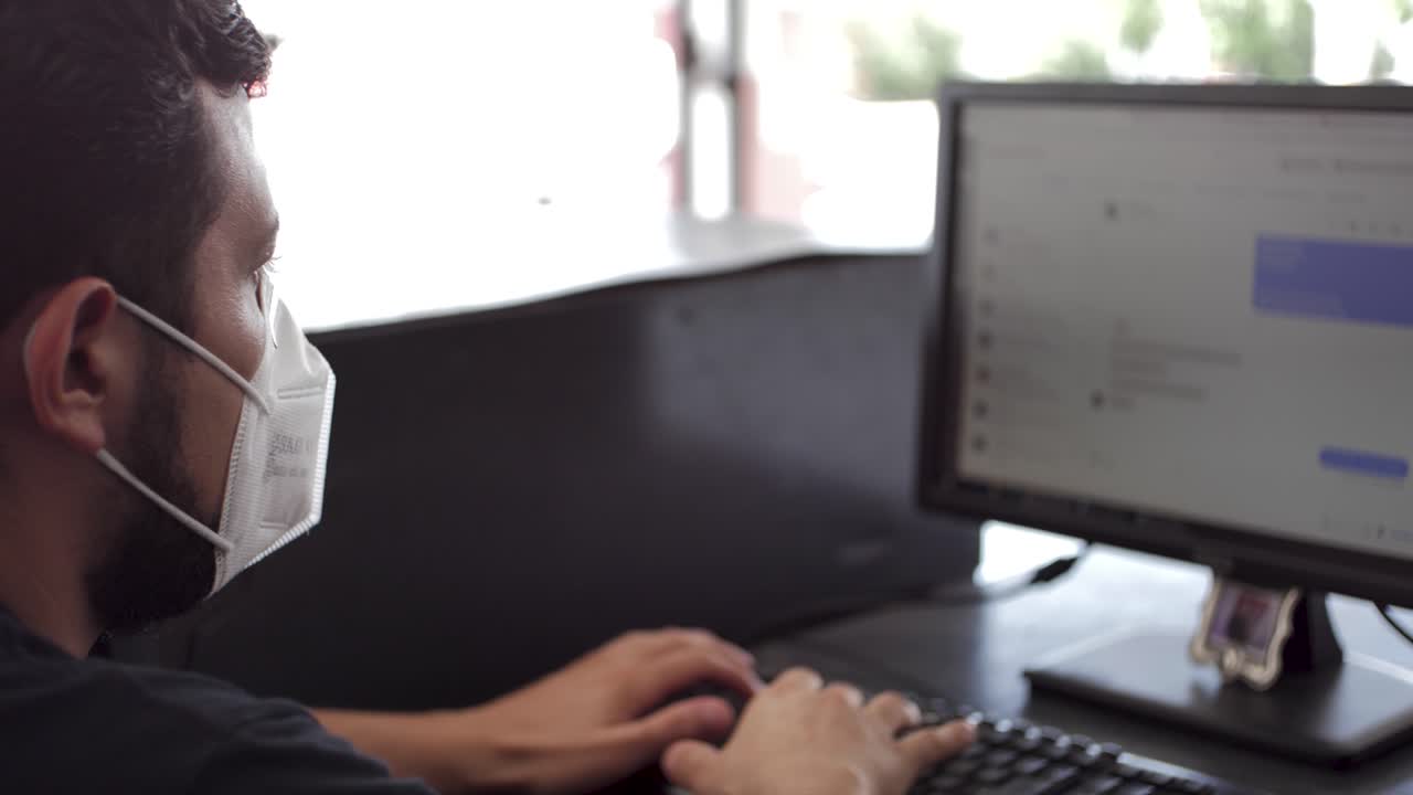 자동차 정비소의 멕시코 소셜 미디어 관리자는 작업 영역에서 입 덮개를 착용하고 covid-19 시간에 고객 메시지를 후속 조치합니다.