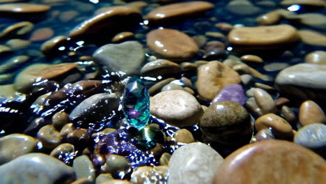 sparkling gemstone on a bed of wet stones