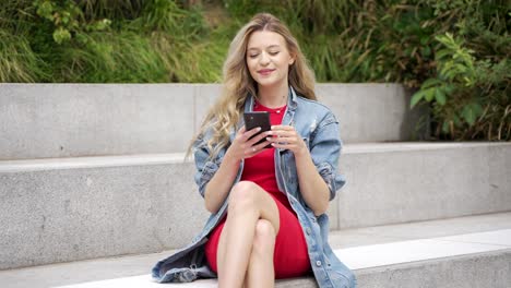 woman using a phone on stairs
