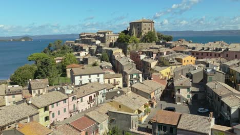 Aerial-around-the-Rocca-Farnese-Castle-and-town-of-Capodimonte-on-Lake-Bolsena,-Province-of-Viterbo,-Italy