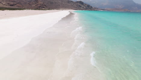 flying over shoab beach with turquoise seascape in socotra island, yemen - drone shot