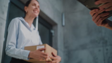 person receiving a package from a delivery courier