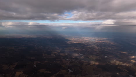 dramatic clouds over upstate new york, usa, from plane window