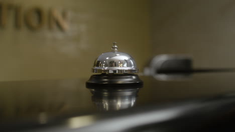 man pressing reception desk bell