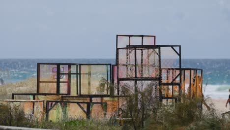 people walking by colorful beach art installation