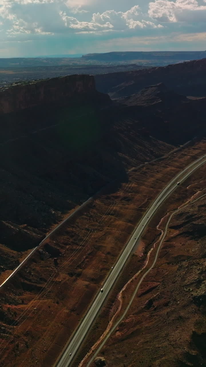 Splendid relief in the Utah National Park. Amazing scenery of rocks and valleys lit by sun from aerial perspective. Vertical video