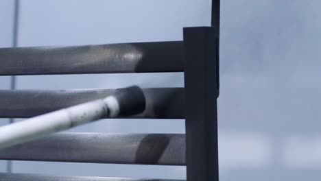 a worker paints a stainless steel metal structure with an airbrush spray gun. dry painting method.