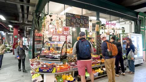 shoppers interact at a vibrant food stall