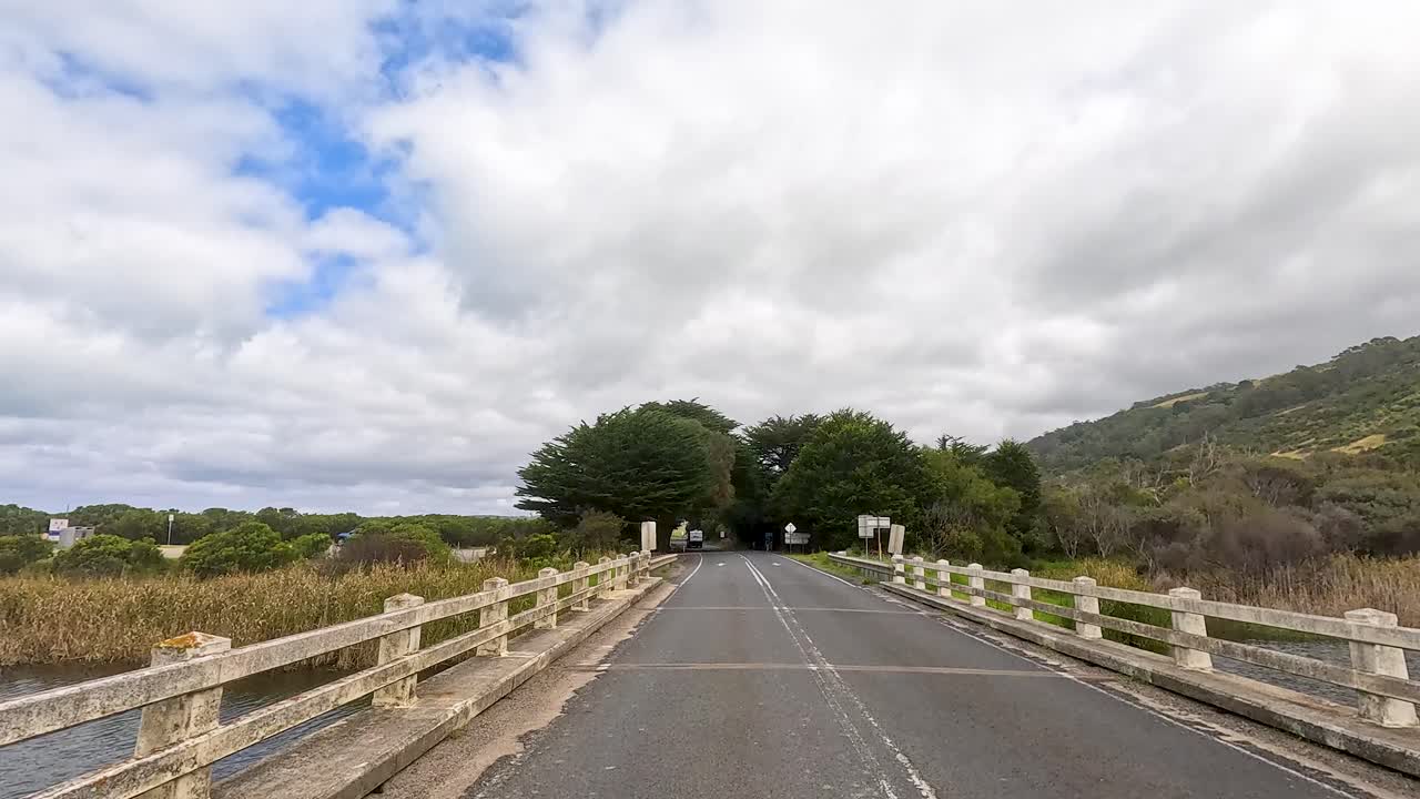A serene drive through lush landscapes and coastal views on Great Ocean Road, captured in natural daylight
