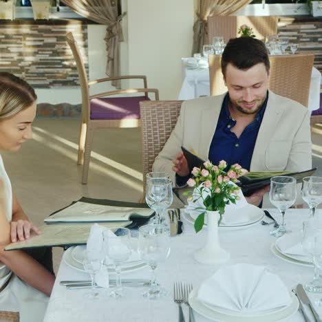 family read menus in a restaurant