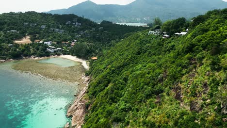 aerial fly above koh phangan islet secluded beach landscape in jungle mountain village surroundings, southeast asian travel destination establishing shot