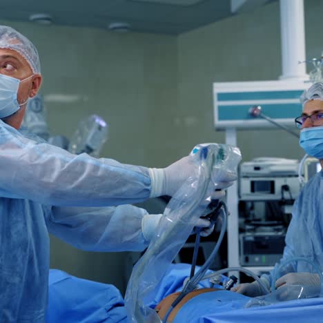 group of doctors perform an operation to a patient. surgeons in medical uniform and masks working in the operating room.