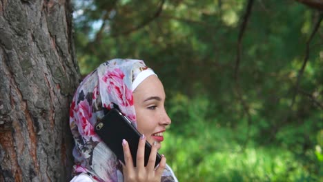 woman in hijab talking on phone outdoors