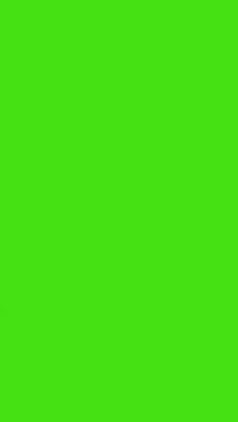 vertical video silhouette of man with wireless headphones walking across frame against green screen
