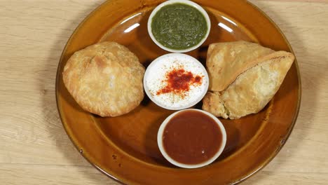 samosa and kachori being served with condiments, top-shot