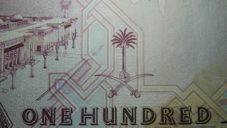 this is the macro view of a normal paper bank not- money- currency ofsaudi arabia 100 riyals bill