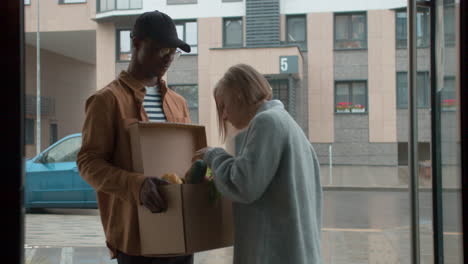 courier delivering box of vegetables