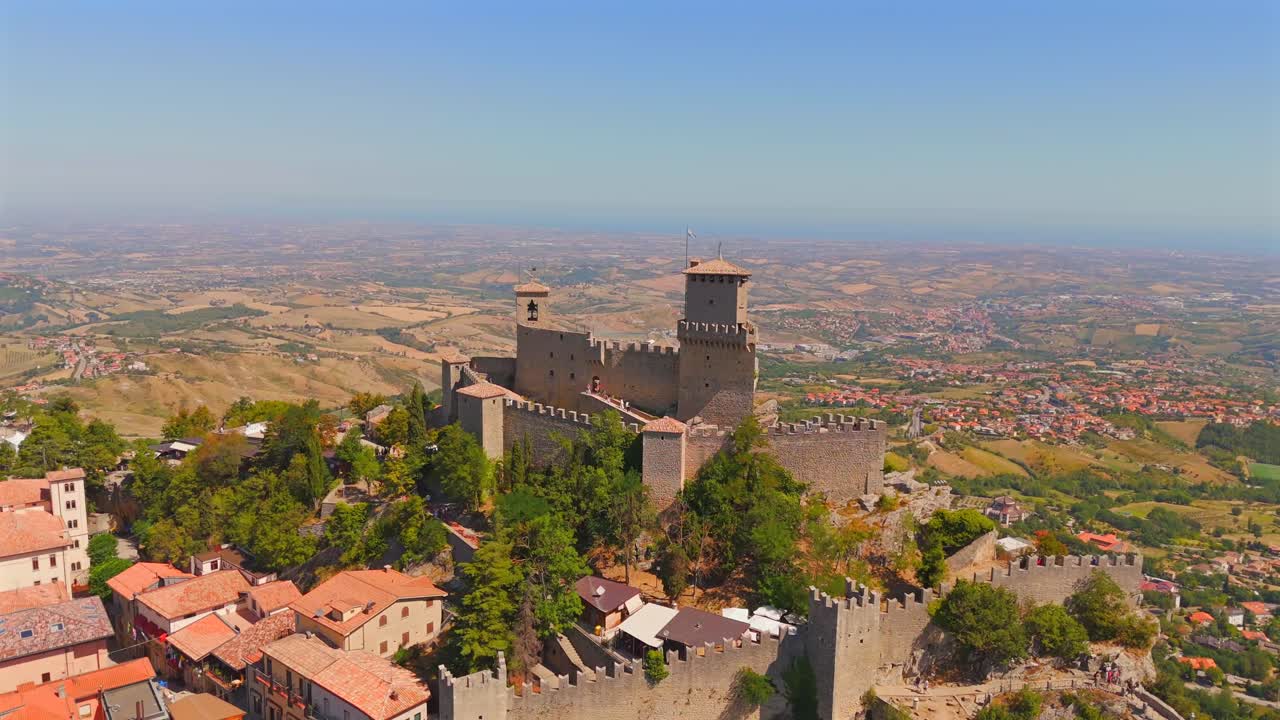 Aerial footage of San Marino reveals its legendary castles amidst rolling green hills and panoramic views.