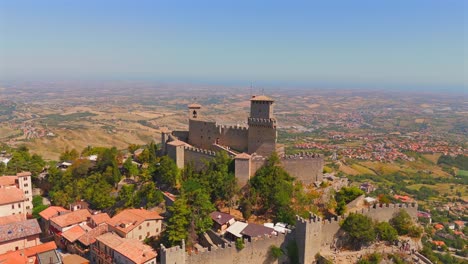aerial footage of san marino reveals its legendary castles amidst rolling green hills and panoramic views.