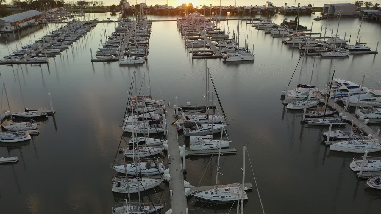Reverse reveal drone view of Marina and sunset over Lake Pontchartrain
