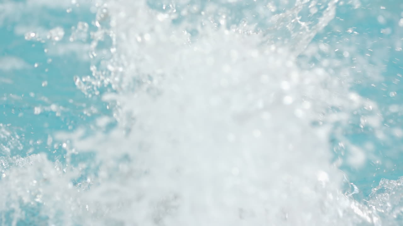 Splashing water in swimming pool, creating dynamic and refreshing scene